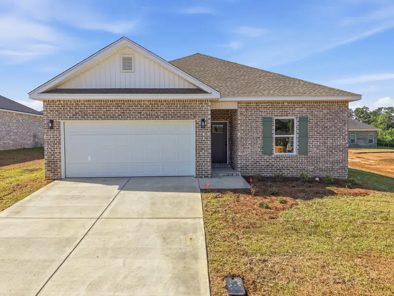 Front exterior of a new home in McCarthy Estates, Defuniak Springs, FL, highlighting curb appeal (Image 1). Front exterior of a new home in McCarthy Estates, Defuniak Springs, FL, highlighting curb appeal (Image 1).