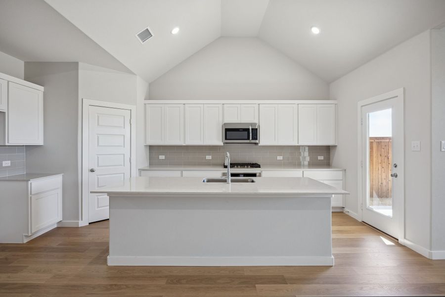 Kitchen in the Wimbledon home plan by Trophy Signature Homes – REPRESENTATIVE PHOTO