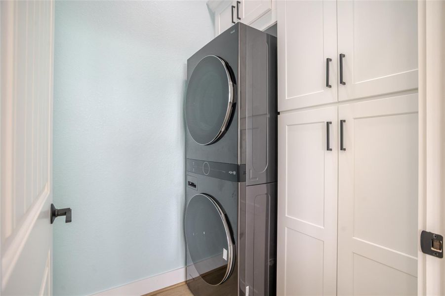Large double stacked washer and dryer on the main floor with lots of cabinet space