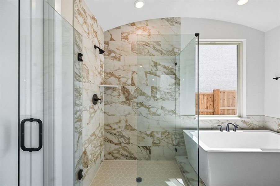 Full bath featuring a stall shower, a freestanding tub, tile walls, and recessed lighting