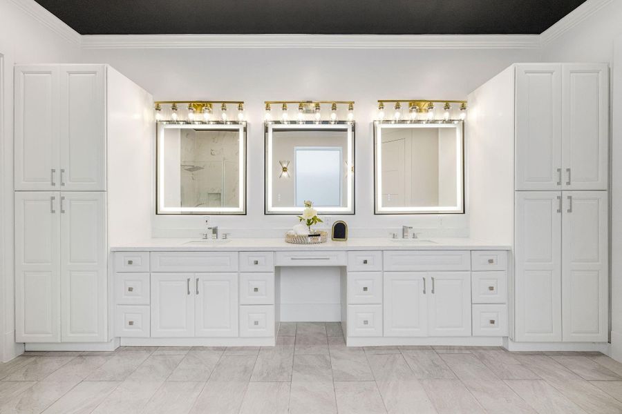 Plenty of storage in your primary bathroom with double sinks.