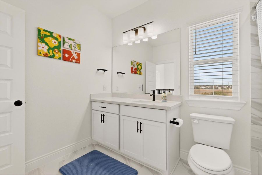 Bathroom featuring vanity and baseboards