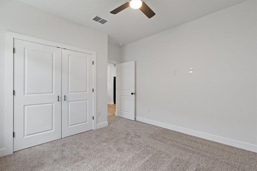 Spacious room featuring neutral carpeting and white walls