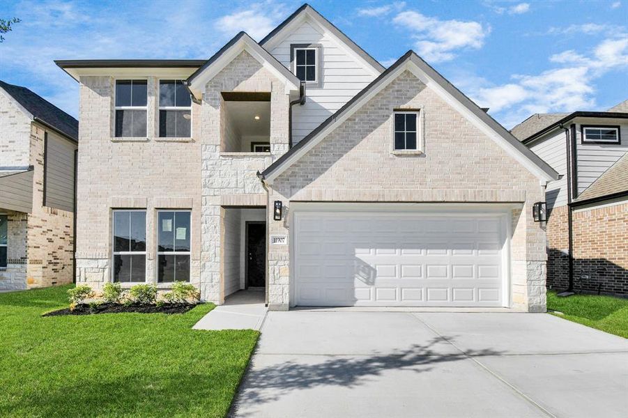 Home showcases a convenient 2-car garage paired with a spacious driveway, providing ample room for parking.