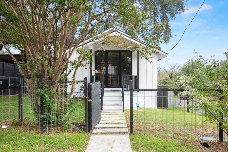 Bungalow-style home featuring a gate, a fenced front yard, and board and batten siding