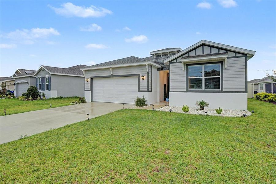 Front exterior of a new home in Abbott Park, Zephyrhills, FL, highlighting curb appeal (Image 24).
