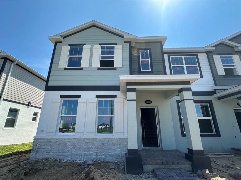 Front exterior of a new home in Tribute at Ovation, Winter Garden, FL, highlighting curb appeal (Image 21).