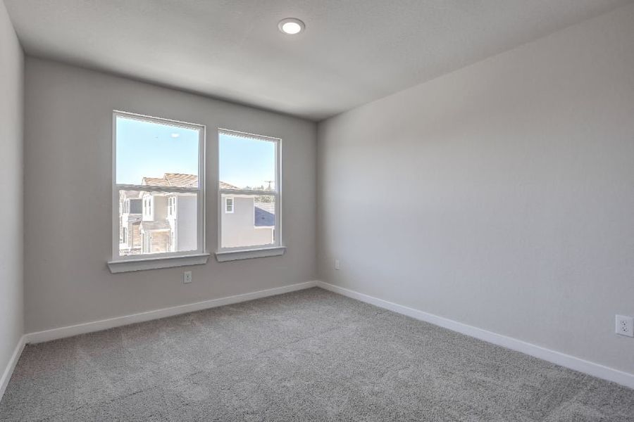 A room with a window and a carpet. A room with a window and a carpet.