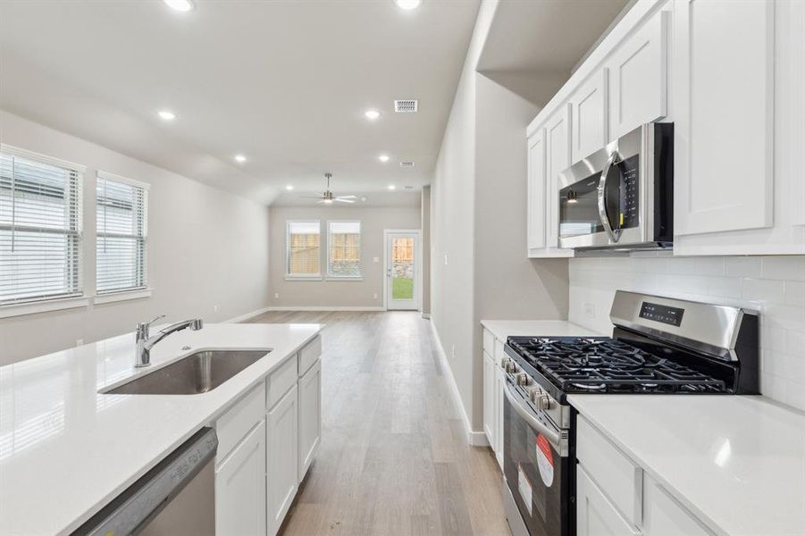 Kitchen in the Elm home plan by Trophy Signature Homes – REPRESENTATIVE PHOTO