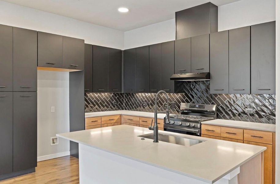 Two-tone cabinetry meets modern solid surface countertops in this architectural kitchen design. Two-tone cabinetry meets modern solid surface countertops in this architectural kitchen design.