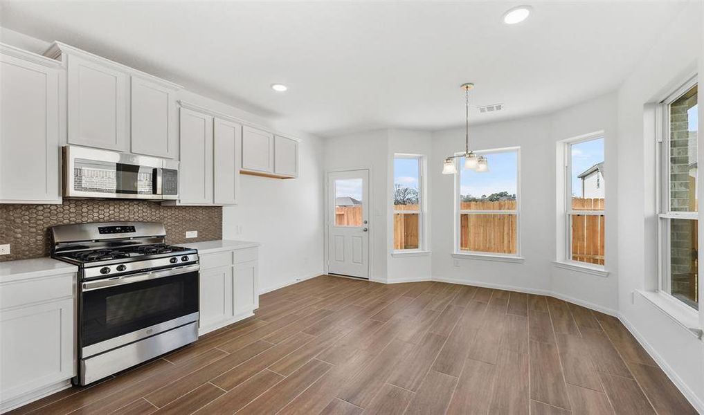 View of kitchen and dining area (*Photo not of actual home and used for illustration purposes only.)