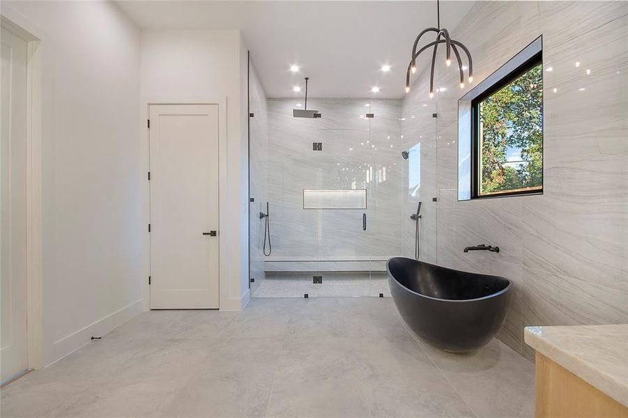 Full bath with a marble finish shower, a freestanding bath, recessed lighting, vanity, and a chandelier
