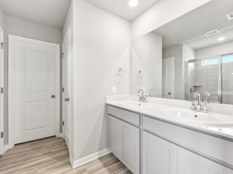 Live in luxury in this primary bathroom with a walk-in shower.