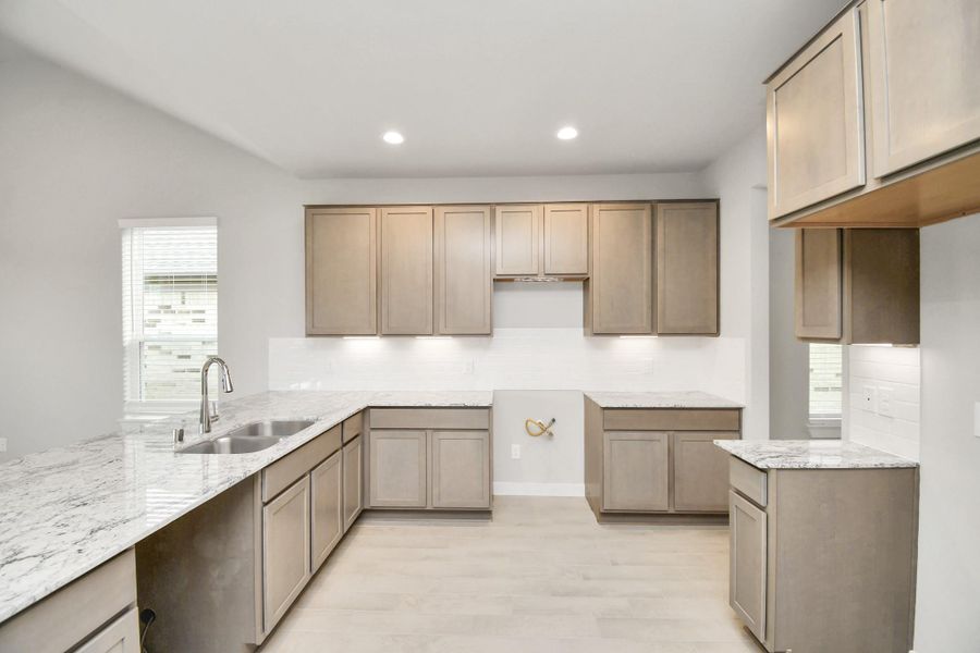 This kitchen is by far any chef’s dream! This spacious kitchen features high ceilings, dark stained wood cabinets, granite countertop, SS appliances (To be Installed), modern tile backsplash, recessed lighting, extended counter space and all overlooking your huge family room.