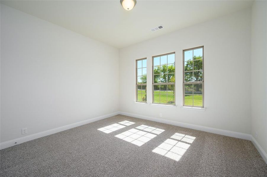 Spare room featuring carpet