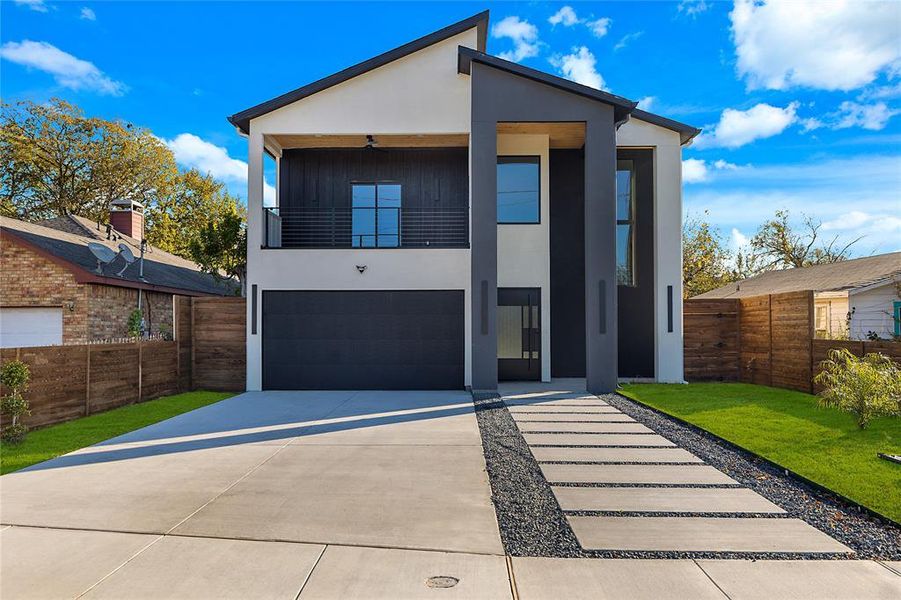 Contemporary home featuring stucco siding, a balcony, concrete driveway, and an attached garage Contemporary home featuring stucco siding, a balcony, concrete driveway, and an attached garage