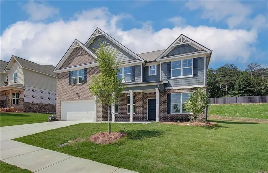 Front exterior of a new home in Kingsmere Estates, Loganville, GA, highlighting curb appeal (Image 22).