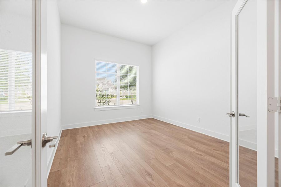 The home office is just off the front entry with double doors for privacy.