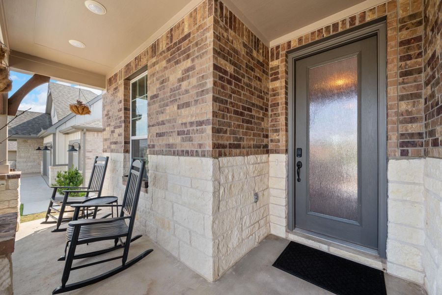 Entrance to property with brick siding and a porch Entrance to property with brick siding and a porch