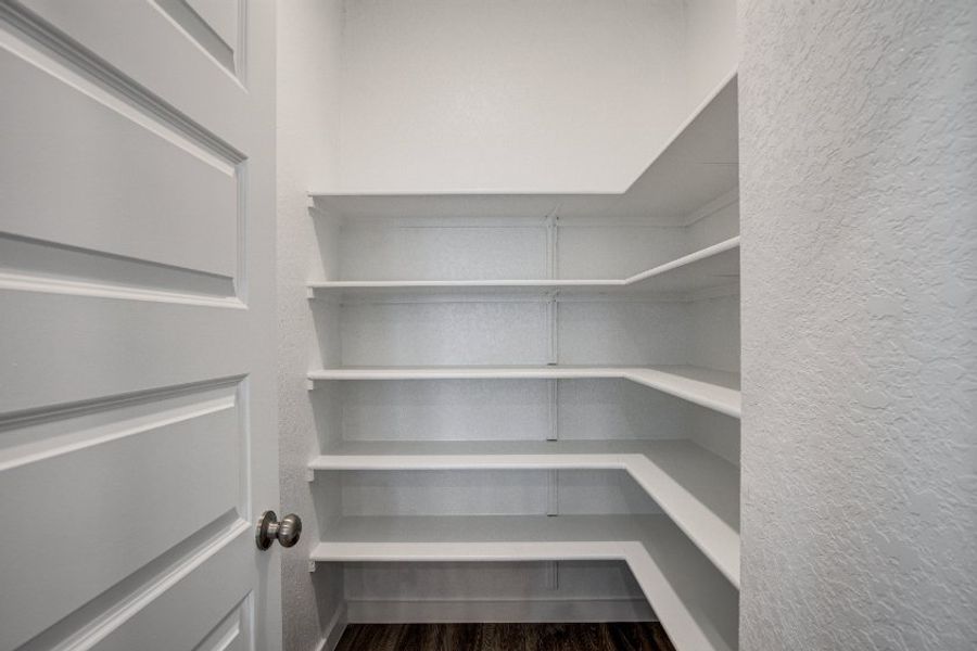 A white shelf with white doors.