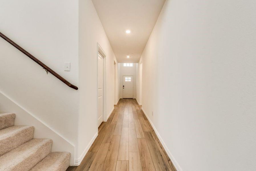 Hall featuring light wood-type flooring