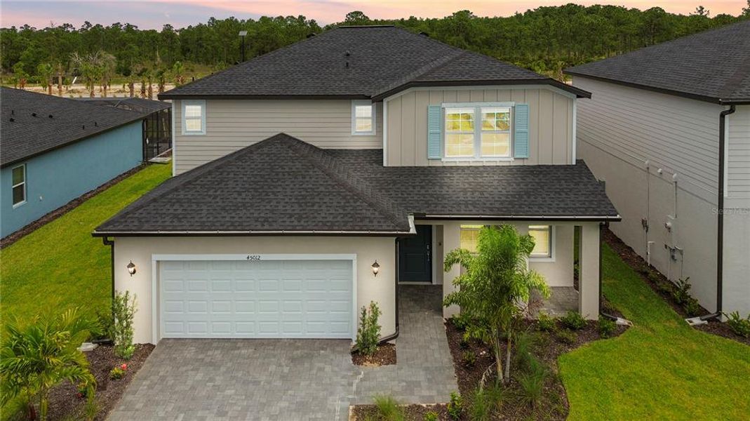 Front exterior of a new home in Sabal Glen at Babcock Ranch, Punta Gorda, FL, highlighting curb appeal (Image 2). Front exterior of a new home in Sabal Glen at Babcock Ranch, Punta Gorda, FL, highlighting curb appeal (Image 2).