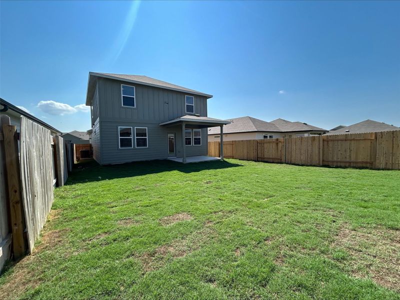 Back of house featuring a patio, a fenced backyard, and board and batten siding Back of house featuring a patio, a fenced backyard, and board and batten siding