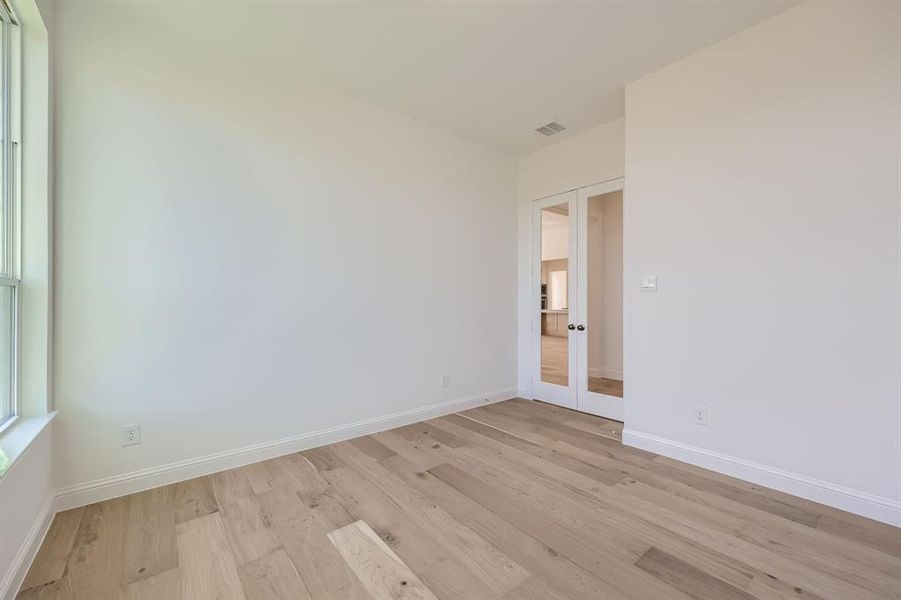 Spare room with light hardwood / wood-style flooring