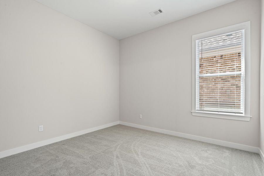 Unfurnished room featuring light colored carpet and baseboards