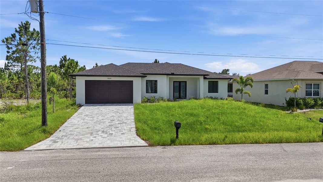 Front exterior of a new home in , Port Charlotte, FL, highlighting curb appeal (Image 2). Front exterior of a new home in , Port Charlotte, FL, highlighting curb appeal (Image 2).