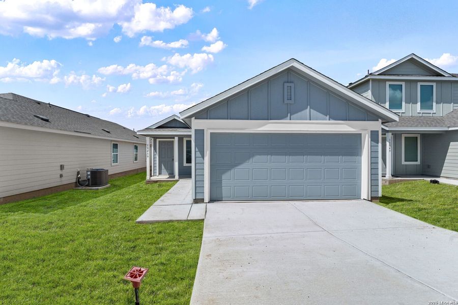 Front exterior of a new home in Hidden Oasis, San Antonio, TX, highlighting curb appeal (Image 2).