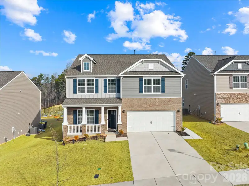Front exterior of a new home in Adair Woods, Davidson, NC, highlighting curb appeal (Image 1). Front exterior of a new home in Adair Woods, Davidson, NC, highlighting curb appeal (Image 1).