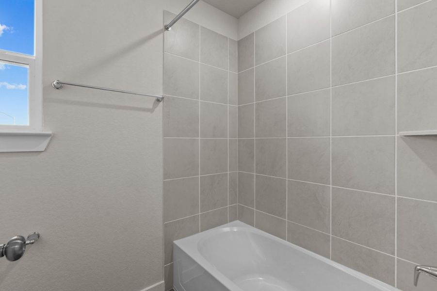 A bathtub and a shower unit. A bathtub and a shower unit.