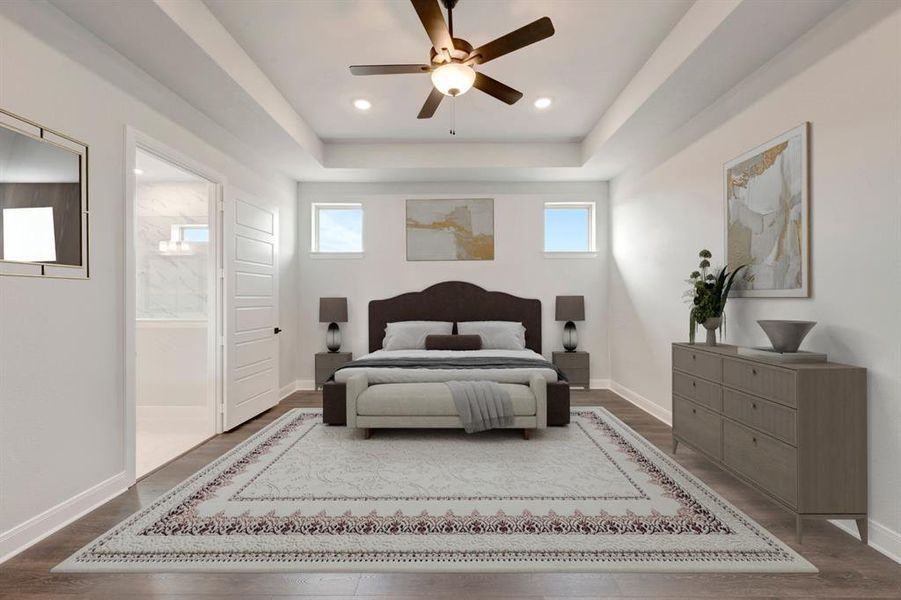 Bedroom with a raised ceiling, wood finished floors, a ceiling fan, ensuite bathroom, and recessed lighting