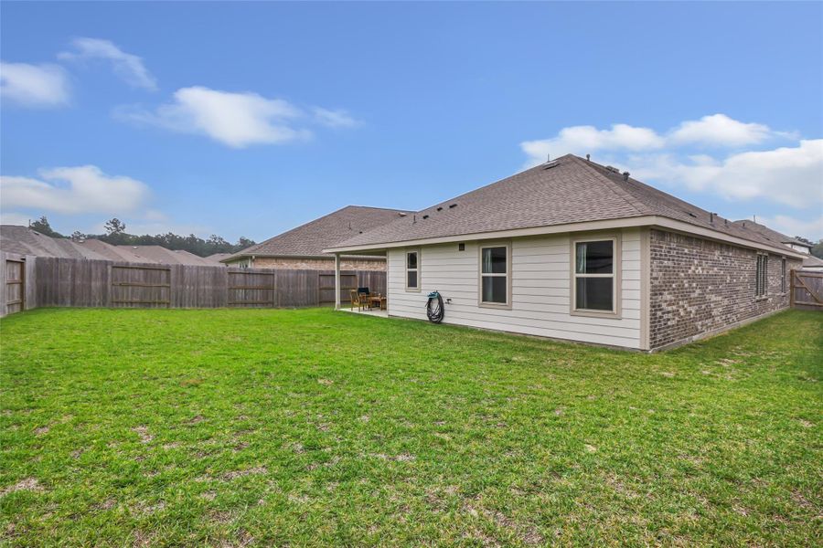 Exterior details and patio area of a home in Pinewood at Grand Texas, New Caney (Image 26).
