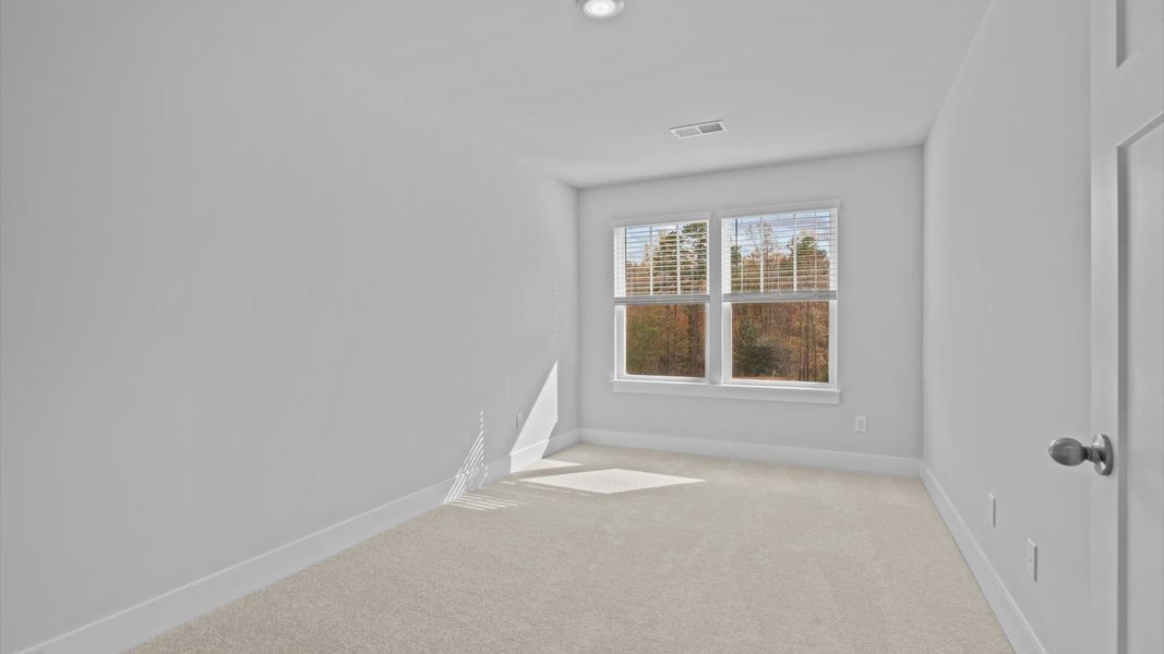 Inviting bedroom with tasteful finishes and large windows that create a fresh, open ambiance Inviting bedroom with tasteful finishes and large windows that create a fresh, open ambiance