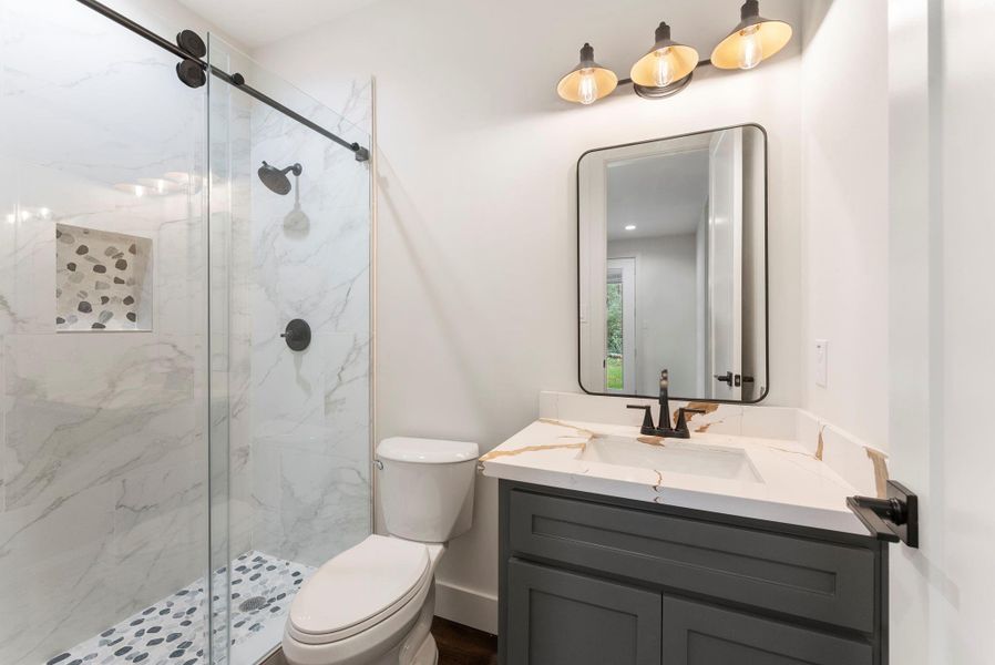 Another bathroom with a walk-in standing shower.
