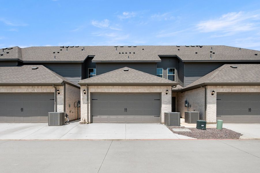 Front exterior of a new home in Sanger Circle – Townhomes, Sanger, TX, highlighting curb appeal (Image 27). Front exterior of a new home in Sanger Circle – Townhomes, Sanger, TX, highlighting curb appeal (Image 27).