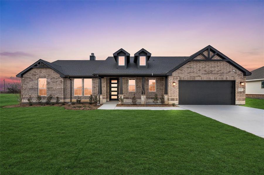 View of front of home with a lawn, brick siding, and driveway View of front of home with a lawn, brick siding, and driveway