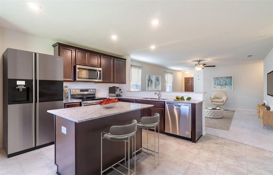 Spacious kitchen with eat-in bartop island *Model Representation*