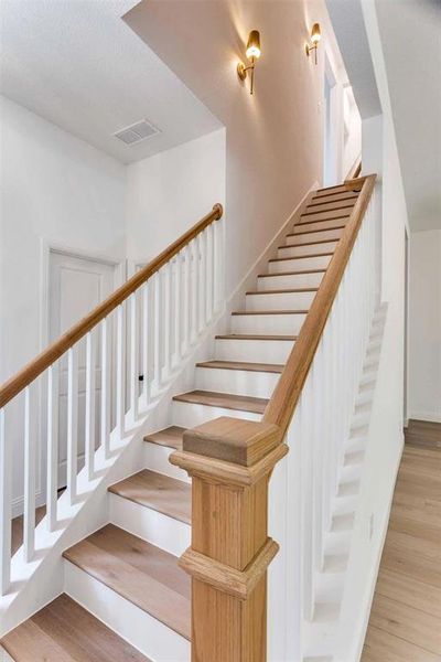 Stairway featuring wood finished floors and baseboards