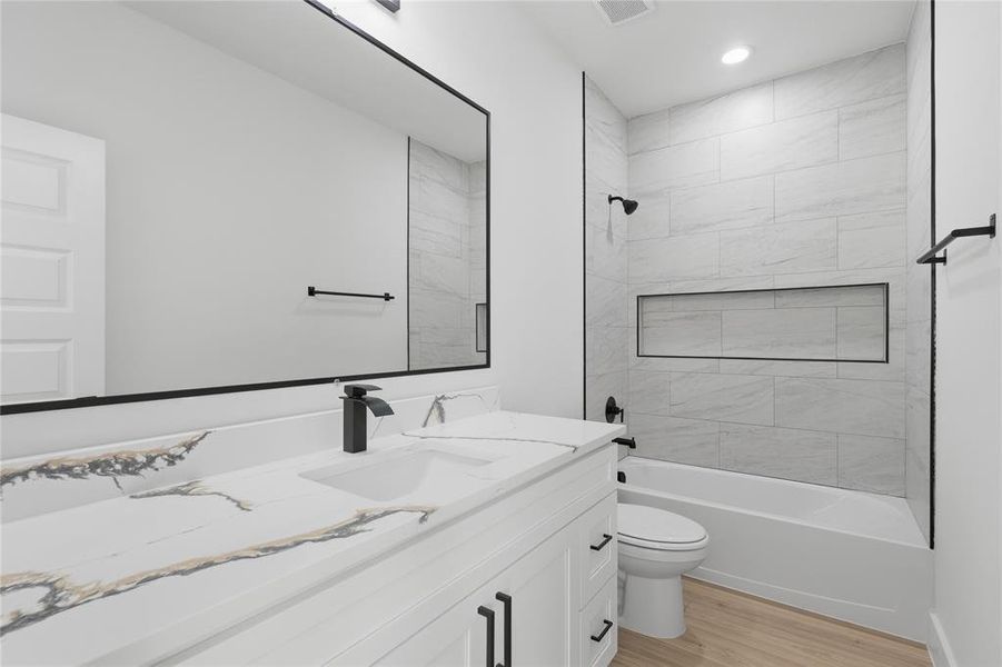 Bathroom featuring vanity, light wood-style floors, washtub / shower combination, and recessed lighting Bathroom featuring vanity, light wood-style floors, washtub / shower combination, and recessed lighting