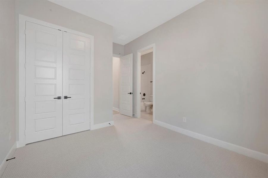 Neutral-toned carpeting paired with light gray walls, white baseboards, and a white ceiling