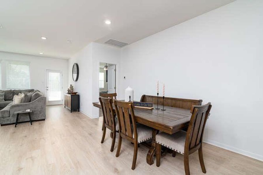 Dining space featuring light wood finished floors and recessed lighting