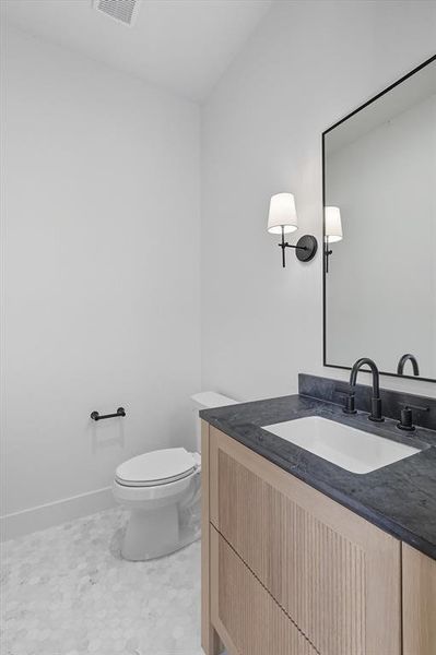 Bathroom featuring vanity and toilet Bathroom featuring vanity and toilet