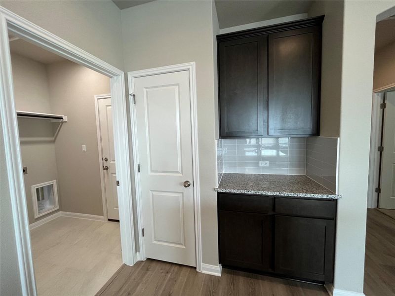 Functional built-in cabinetry and granite counters enrich this versatile transition space. Functional built-in cabinetry and granite counters enrich this versatile transition space.