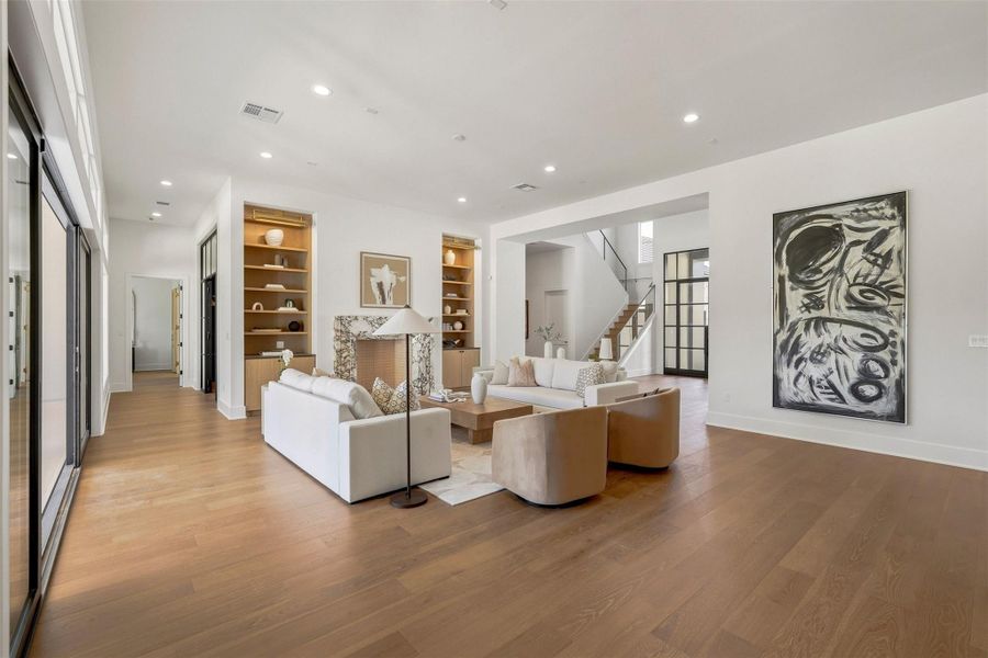 Another view of this living space. To the left, a discreet corridor leads to the first-floor study and the primary bedroom suite. Another view of this living space. To the left, a discreet corridor leads to the first-floor study and the primary bedroom suite.