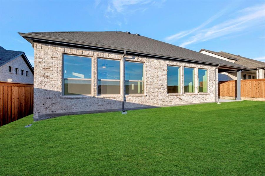 Back of property featuring a fenced backyard, brick siding, and a patio Back of property featuring a fenced backyard, brick siding, and a patio