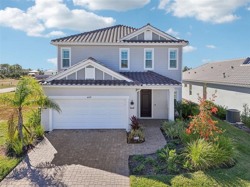 Front exterior of a new home in , Sarasota, FL, highlighting curb appeal (Image 33). Front exterior of a new home in , Sarasota, FL, highlighting curb appeal (Image 33).