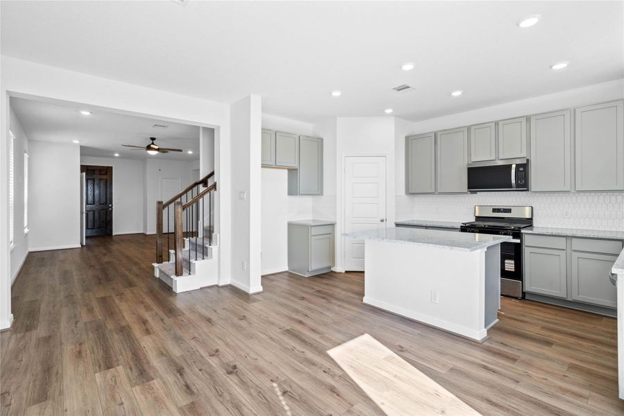 Stunning open-concept design seamlessly connecting the living, dining, and kitchen areas—perfect for both everyday living and entertaining!